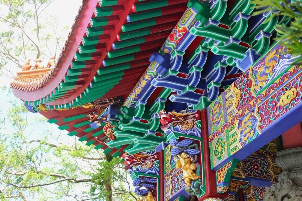 Backpacking trip to a temple in Hong Kong. Colourful temple and trees.