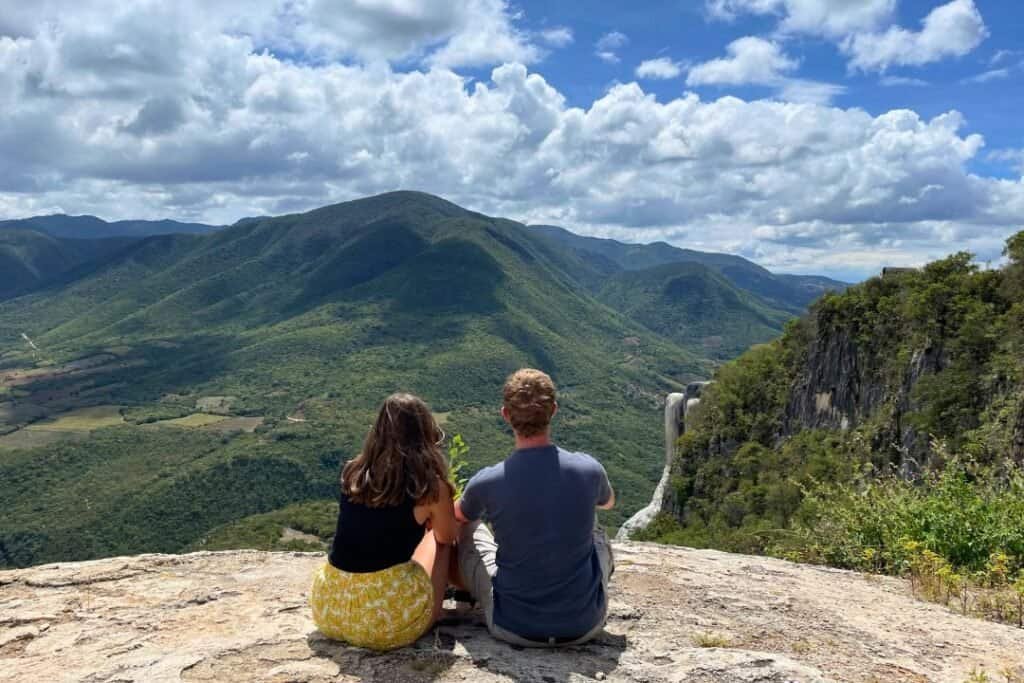 Remote mountain view with waterfall and lush greenery, ideal for backpackers enjoying adventure travel and nature escapes.