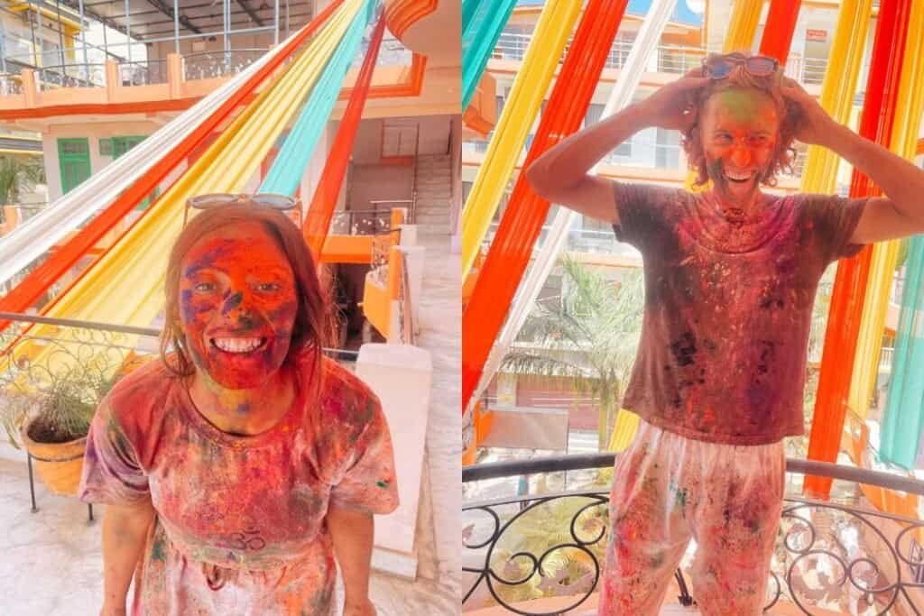 Holi Colorful Holi celebration with joyful woman covered in vibrant powders at a lively, artistic venue featuring bright orange, yellow, and mint-colored decor.