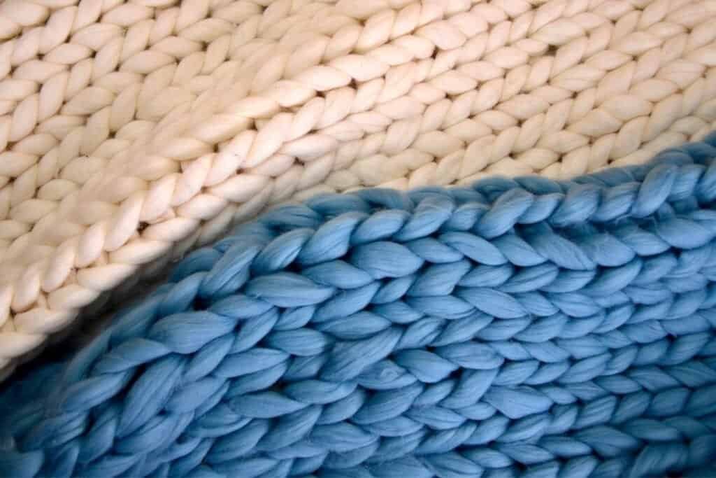 Soft woven baskets made from natural fibers in creamy beige and calming blue tones, emphasizing mindful sustainable craftsmanship.