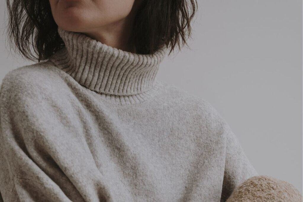 Cozy beige turtleneck sweater, soft fabric and relaxed fit, perfect for sustainable travel and mindful living.