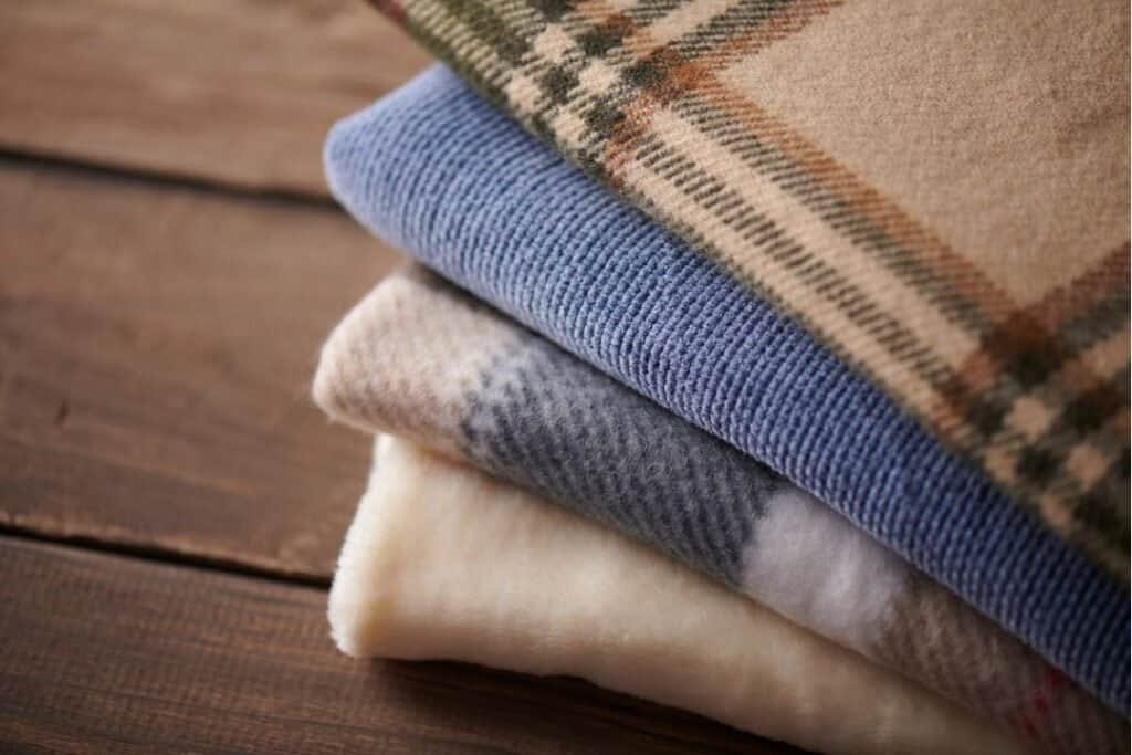 Soft, cozy folded 100% Cashmere Throw Blankets with eco-friendly, sustainable fabrics for mindful comfort and grounded relaxation on your travel journey.