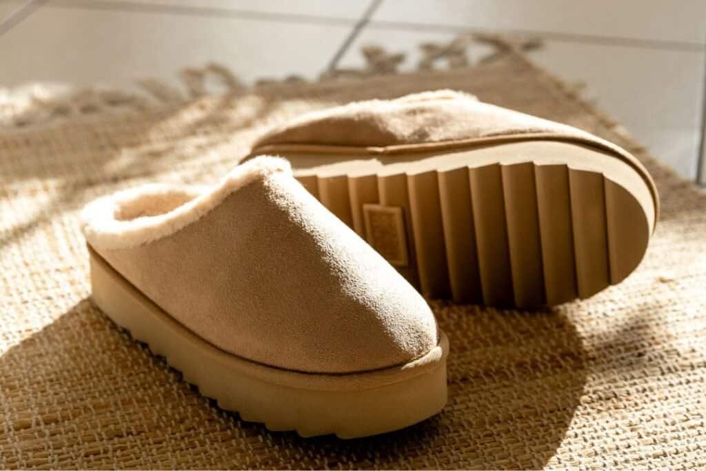 Cozy beige slippers on a woven mat, embodying comfort and grounding for mindful living and sustainable travel experiences.