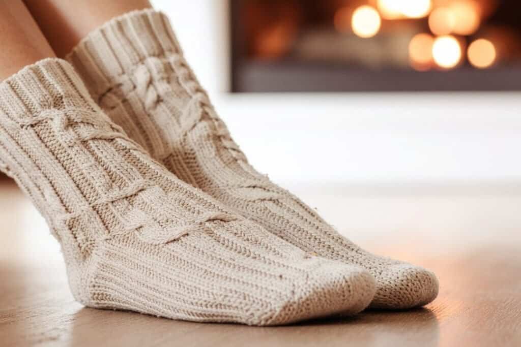 Cozy, knitted 100% wool socks perfect for sustainable, mindful travel and relaxing moments at home by a warm fireplace.