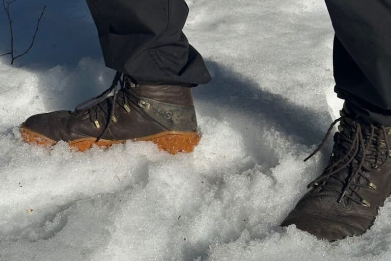 Wide toe box hiking boots on snowy ground.