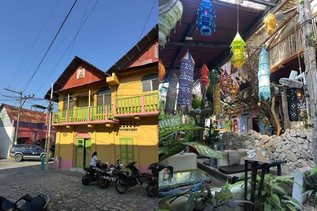 A colorful two-story building with vibrant yellow and green accents, surrounded by motorcycles and a cobblestone street.