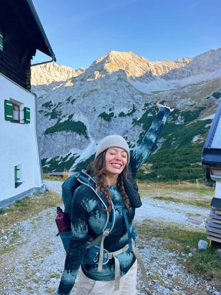 Ellen on a hut-to-hut hike in a merino wool base layer, cashmere hat and Osprey Talon 22L