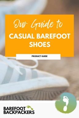 Worn white casual barefoot shoes on sandy ground, highlighting comfort and simplicity for barefoot travel and outdoor adventures.